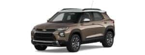 A brown and white 2021 Chevy Trailblazer is facing left.