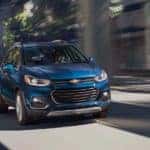 A blue 2020 Chevy Trax is racing away with a win between 2020 Chevy Trax vs 2020 Chevy Equinox.