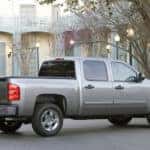 Silver 2009 Chevrolet Silverado parked in front of a blue and white estate