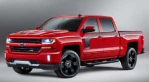 Red and black Chevy Silverado truck against a grey background