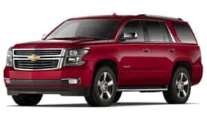 A red 2016 Chevy Tahoe is angled left.