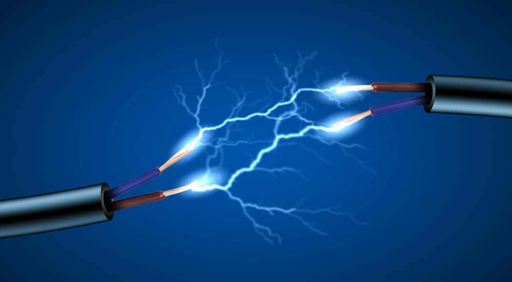Two silver poles with red and blue cords coming out of them shooting connecting lightening bolts to one another
