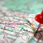 Red tack stuck into "Albany" on a map of New York