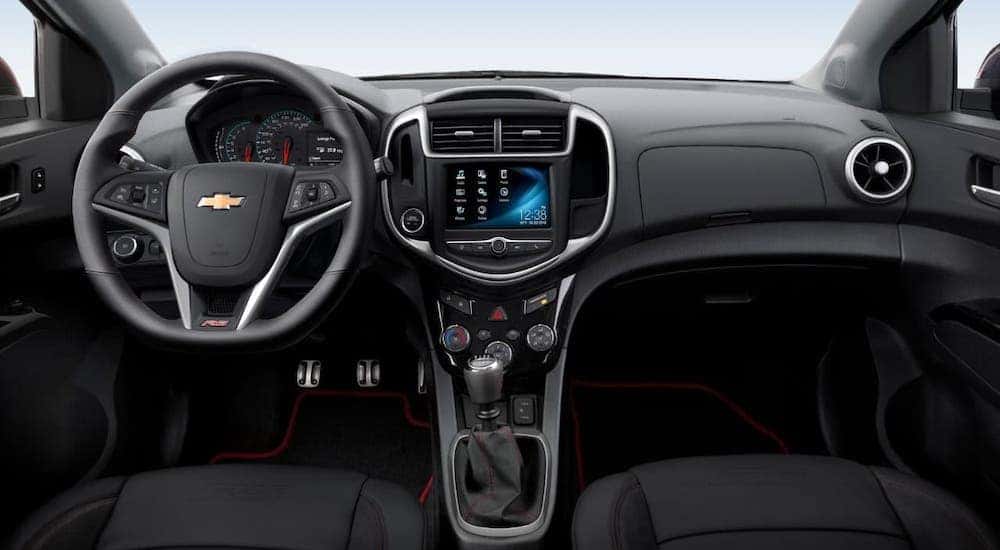The back interior and dashboard is shown inside a 2020 Chevy Sonic.
