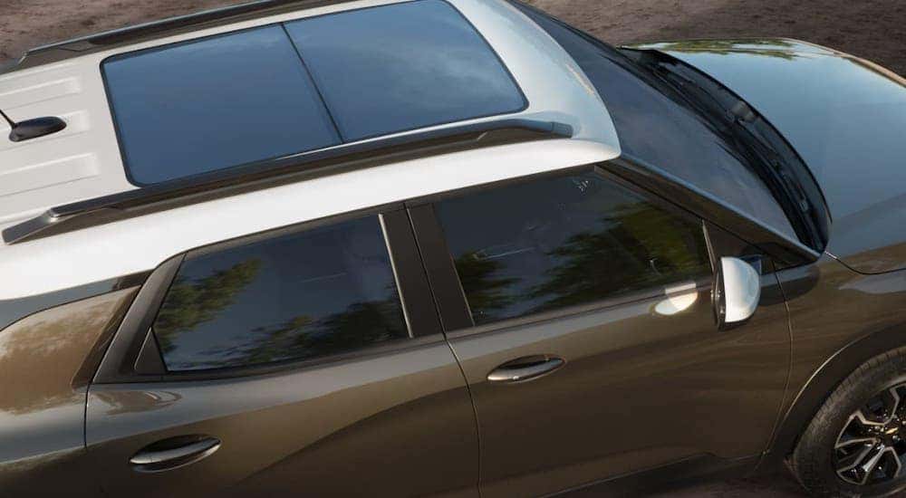 A closeup is showing the top of a brown and white 2021 Chevy Trailblazer from a Chevy dealership near Clifton Park, NY.