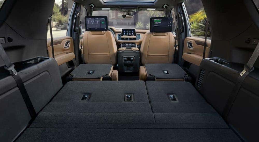 The rear seats are shown folded down in the back of a 2021 Chevy Suburban.