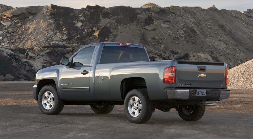 Grey 2009 Chevrolet Silverado parked in front of tall mountains