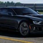 A black 2021 Chevy Camaro is parked on a racetrack after leaving a Chevy dealership near Clifton Park, NY.