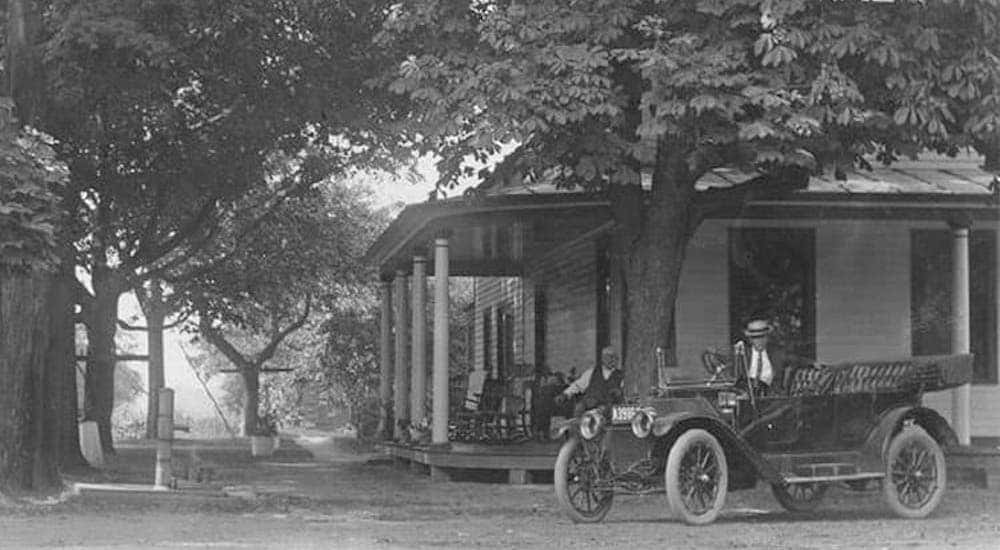 A black and white photo shows an antique car in front of the Grooms Tavern in Clifton Park, NY.