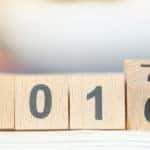 Wooden number blocks that say "2016" with the one halfway flipped to a "7"