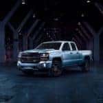 Silver 2018 Chevrolet Silverado Redline edition parked in a dark room