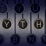 Black and silver letter disks on black strings that spell out "Myths" against a grey background