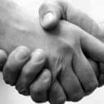 Black and white close-up of two people shaking hands