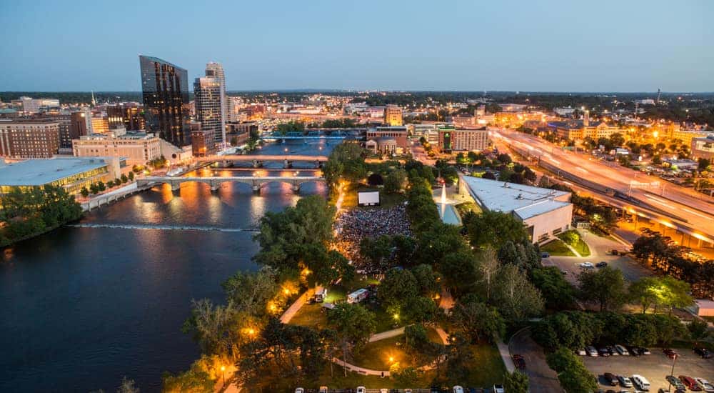 Aerial view of city lights, trees, buildings, and water in Grand Rapids Michigan