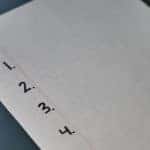 White lined paper with the numbers "1, 2, 3, and 4" written down in black along the left side