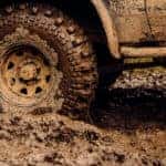 Close-up of tires driving through the mud