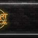 White and yellow LED sign with the words "EXPERT ADVICE" on it against a black brick wall