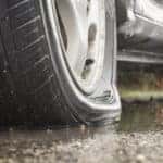 Close-up of a flat tire on pavement