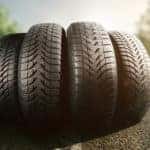 Four tires upright in the middle of a paved road