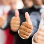 Multiple businesspeople lined up and giving thumbs up