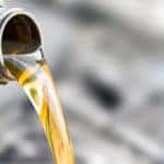 Oil pouring out of a grey bottle