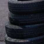 Stack of black tires on pavement