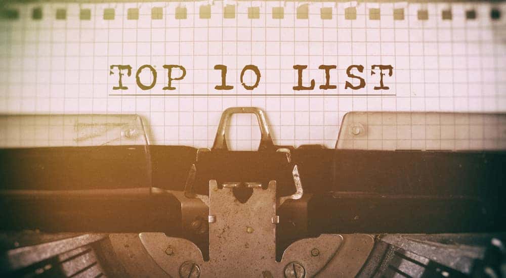 Piece of grid paper sitting in a typewriter with the words "TOP 10 LIST" typed on it