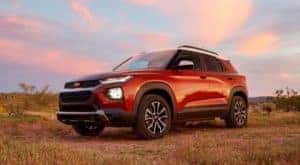 A red 2021 Chevy Trailblazer is parked against a blue and pink cloudy sky after leaving a Chevy dealership in Clifton Park.