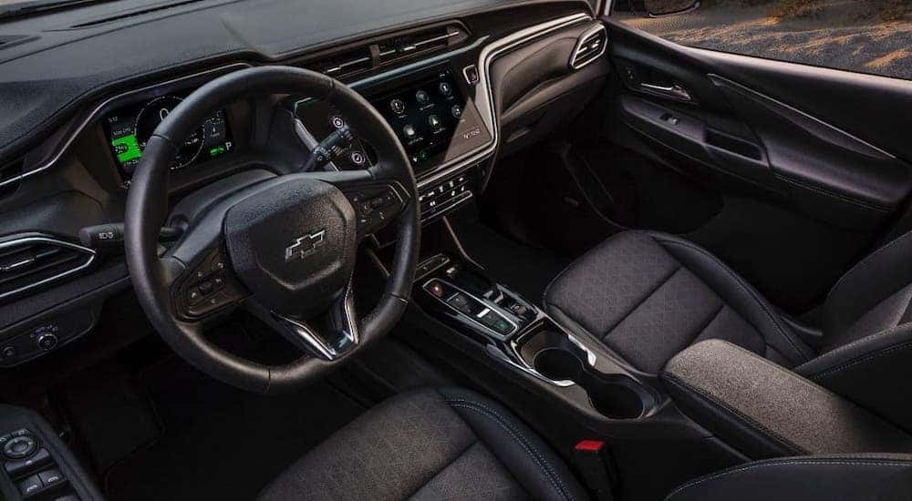 The black interior and dashboard of a 2022 Chevy Bolt EV are shown from a high angle.