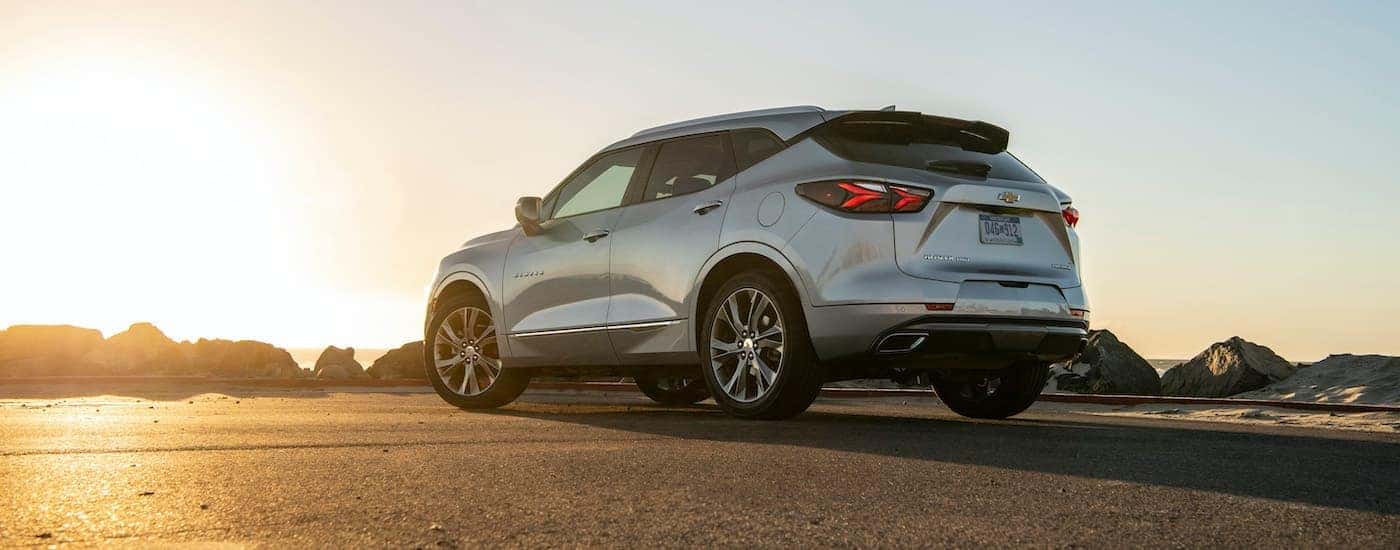 A silver 2021 Chevy Blazer is shown from the rear at sunset.