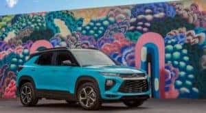 A teal 2021 Chevy Trailblazer RS is shown parked in front of a mural after leaving an Albany Chevy crossover dealer.