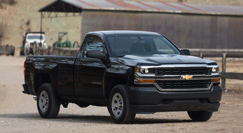 A black 2016 Chevy Silverado, purchased though Chevy sales in Albany, is shown parked at a farm.