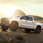 A white Chevy Silverado is shown parked in the desert after looking up NY Chevy truck sales.