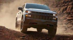 A white 2021 Chevy Silverado 1500 diesel is off-roading in the desert.