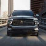 A grey 2021 Chevy Tahoe RST is shown driving down a ramp after leaving a Chevy Tahoe dealership.