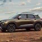 A gold 2022 Chevy Trailblazer Activ is shown parked in a desert after looking for Chevy lease deals.
