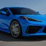 A blue 2022 Chevy Corvette is shown from the side after leaving an Albany car dealership.