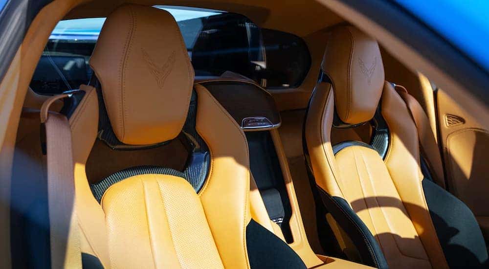 The yellow interior of a 2022 Chevy Corvette shows the seating.
