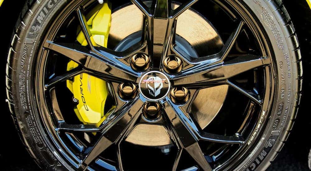 The black rim and yellow caliper on show in closeup on a 2022 Chevy Corvette.