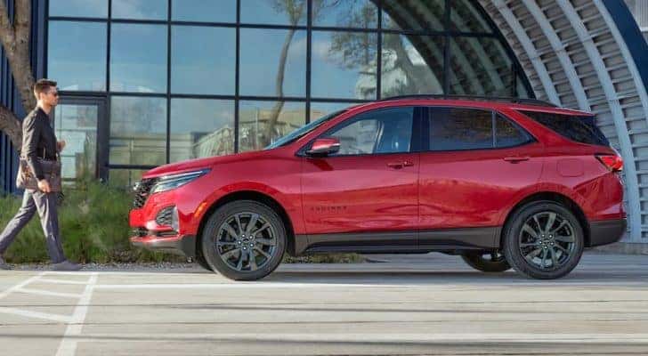 A red 2022 Chevy Equinox is shown from the side after leaving an Albany Chevy Equinox dealer.