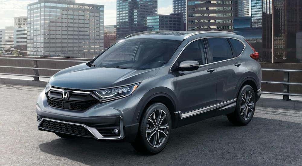 A silver 2020 Honda CR-V Touring is shown parked in the city after visiting a Clifton Park used car dealer.