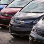 A line of 2017 Chevy Bolts are shown at a certified pre-owned Chevy dealer.