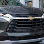 A close up of a black 2022 Chevy Blazer shows the grille and front headlights.