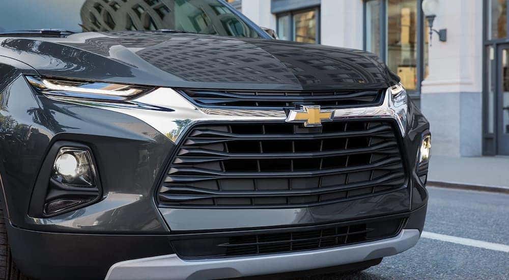 A close up of a black 2022 Chevy Blazer shows the grille and front headlights.