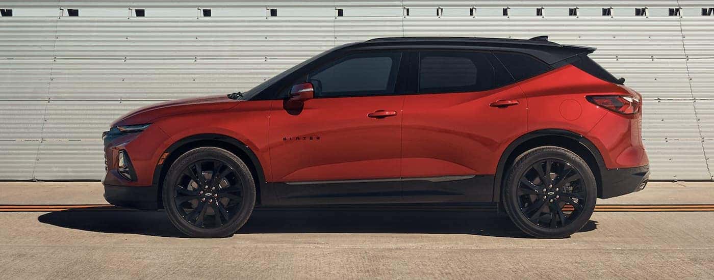 A red 2022 Chevy Blazer is shown from the side after leaving a NY Chevy Blazer dealer.