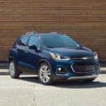 A blue 2018 Chevy Trax is shown parked outside of an Albany certified pre-owned Chevy dealer.