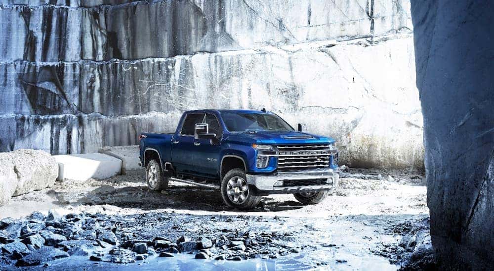 A blue 2021 Chevy Silverado 2500HD is shown parked in a quarry.