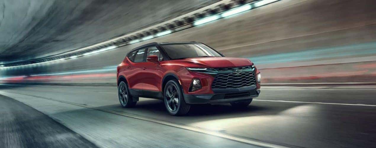 A red 2022 Chevy Blazer RS is shown from the front driving through a tunnel.