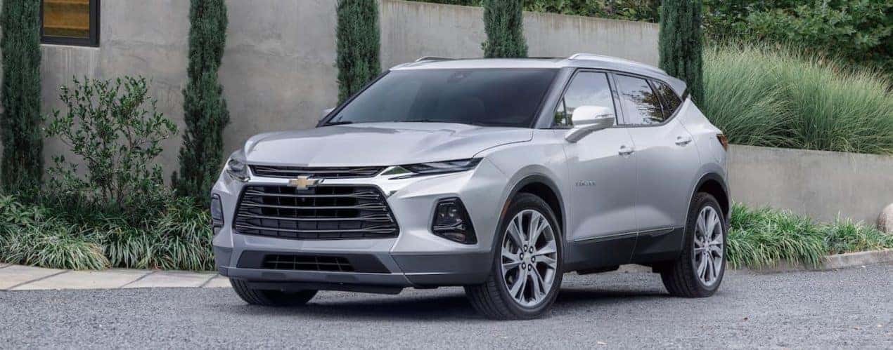 A silver 2022 Chevy Blazer is shown from the side parked in front of a cement wall after winning a 2022 Chevy Blazer vs 2022 Hyundai Santa Fe comparison.