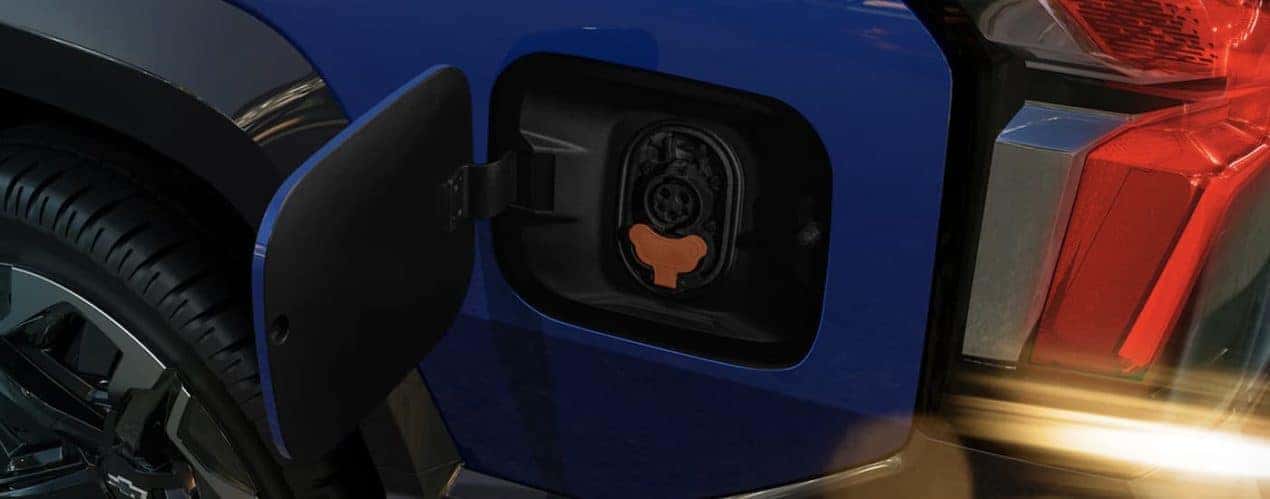 A blue 2024 Chevy Silverado EV is shown in close up.